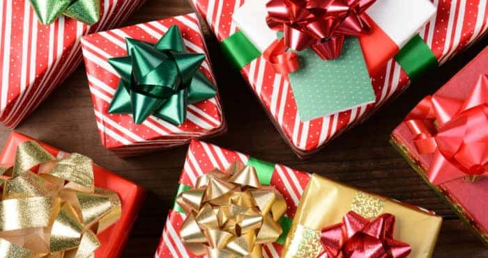 Overhead view of a group of wrapped Christmas presents. Horizontal format filling the frame.