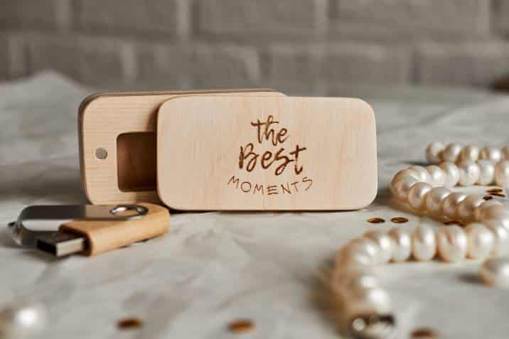A wooden flash drive with an open box engraved with the words, "The Best Moments," Sentimental Valentine's Day gift