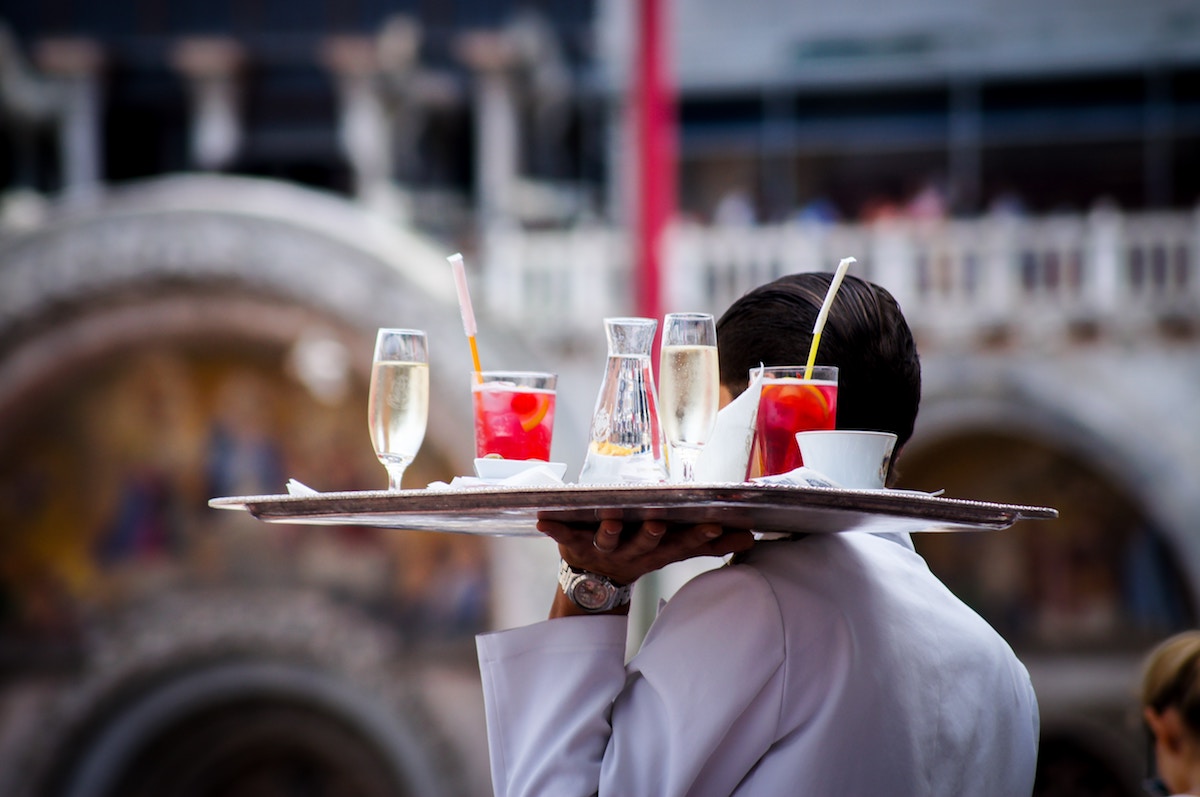 waiter holding drinks tray