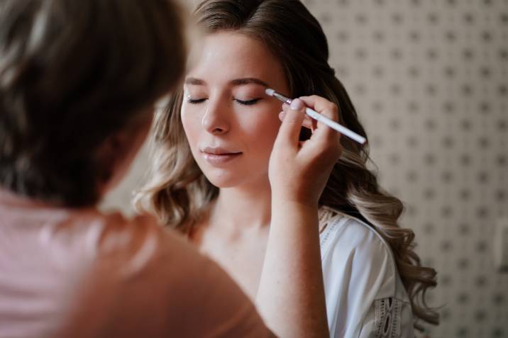 a bride getting her makeup done