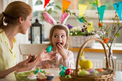 little girl eating chocolate easter eggs