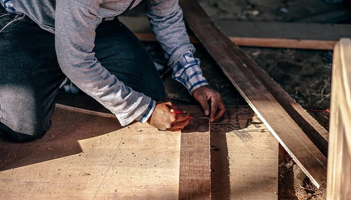 Carpenter measuring to cut