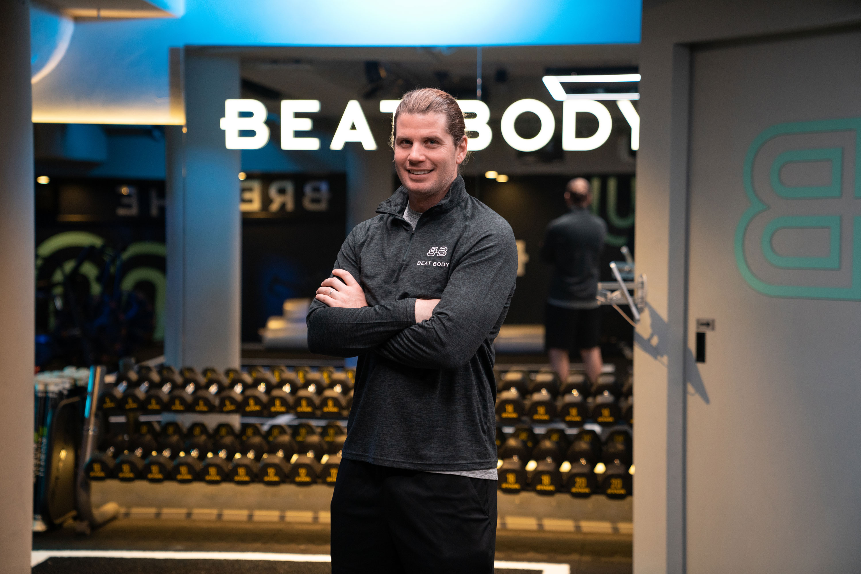 Australian start up founder Tom of Beat Body gym in front of weigh rack