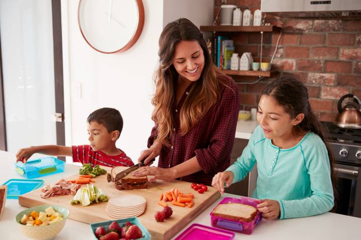 mum packing school lunches for her kids