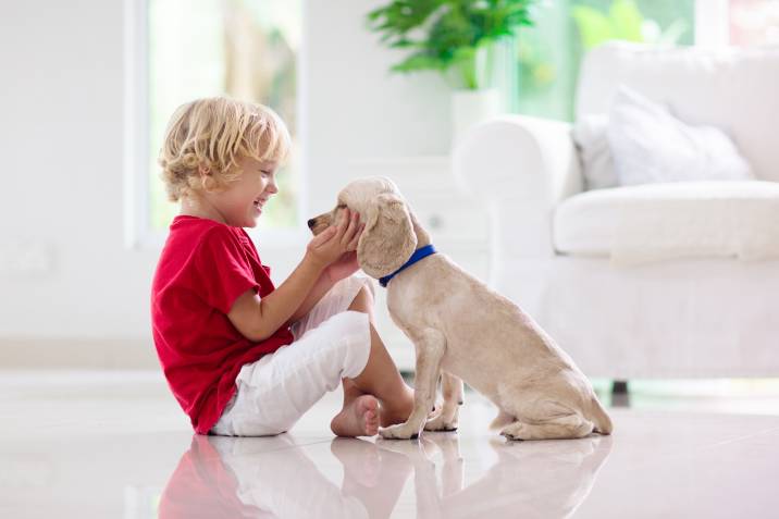 child playing with family pet