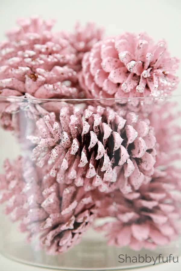 pink painted pinecones with glitter in vase