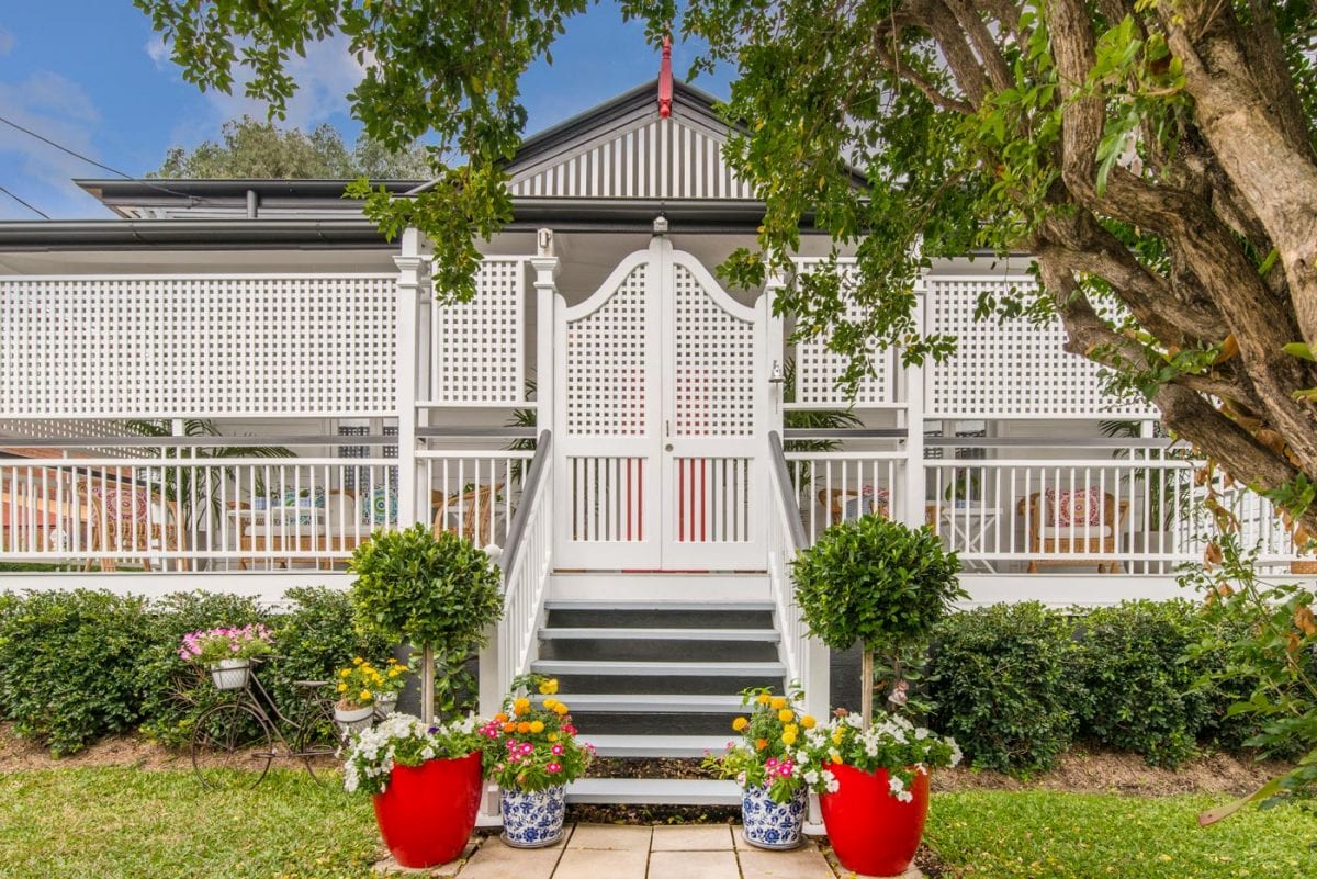 Traditional Queenslander house white fence Airbnb