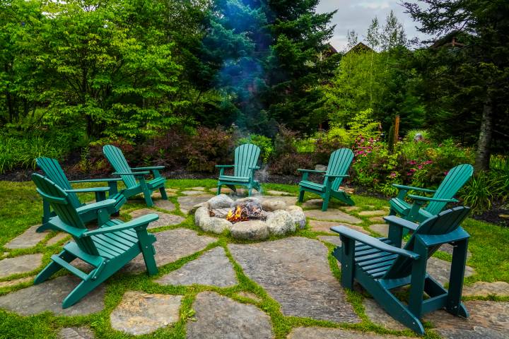 below ground fire pit with teal chairs surrounding