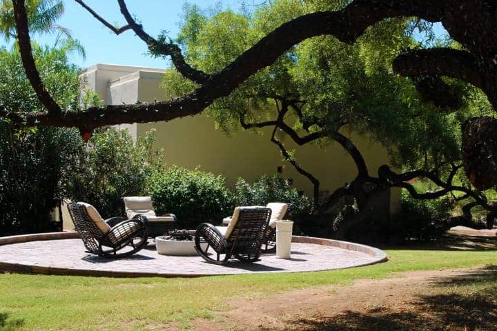 Sitting area surrounded by a fire pit with outdoor brick flooring