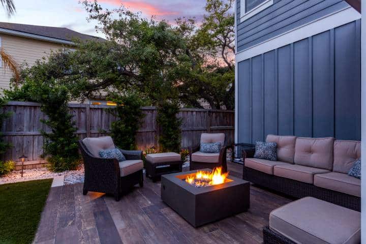 Beautiful backyard fire pit at dusk with comfortable chairs