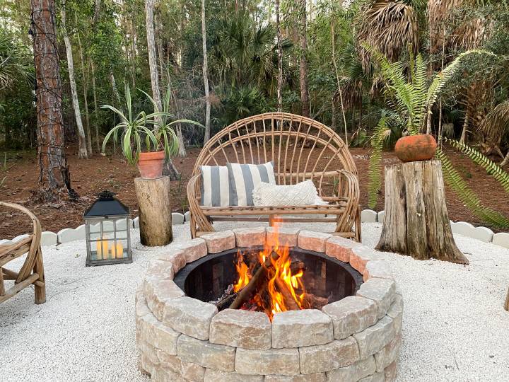 Fire pit bonfire campsite in tropical backyard woods