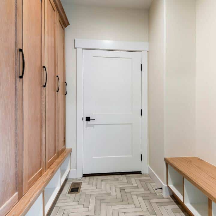 Square mudroom interior with white fire door 