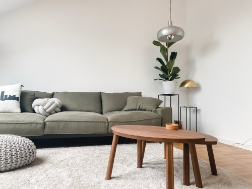 hygge-themed living room with grey sofa and wooden coffee table