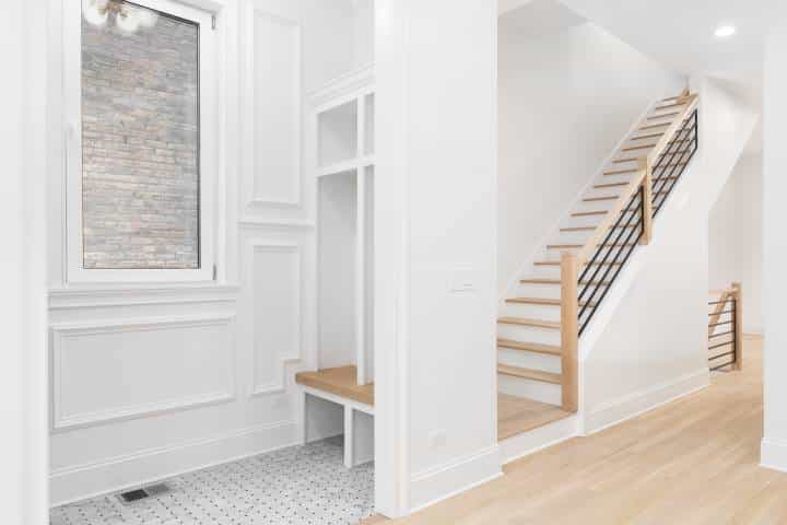 A minimalist clean entryway with a mudroom nook