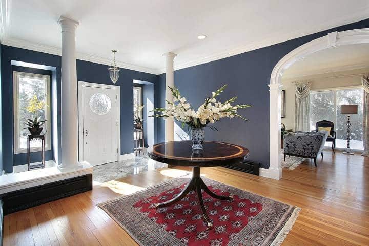 Foyer with white columns and wide round table