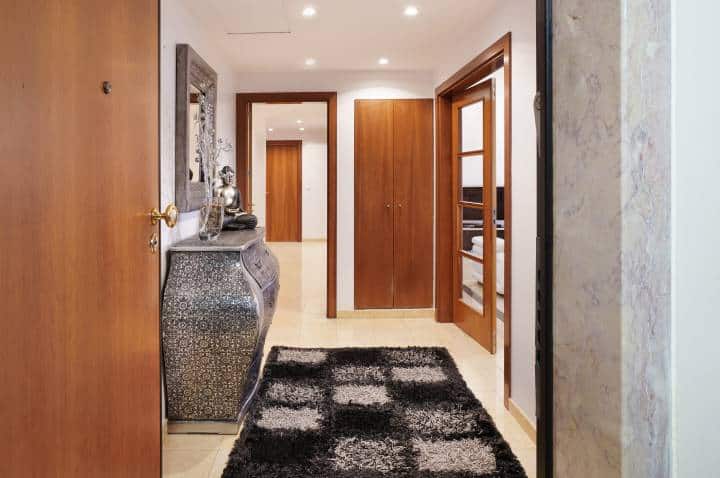 Modern apartment entrance with stylish rug