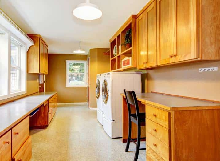 spacious laundry room and home office furnished with shelves and desk with black chair