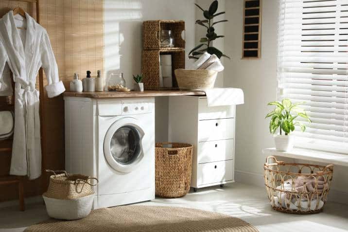 laundry room with modern washing machine and hamper basket