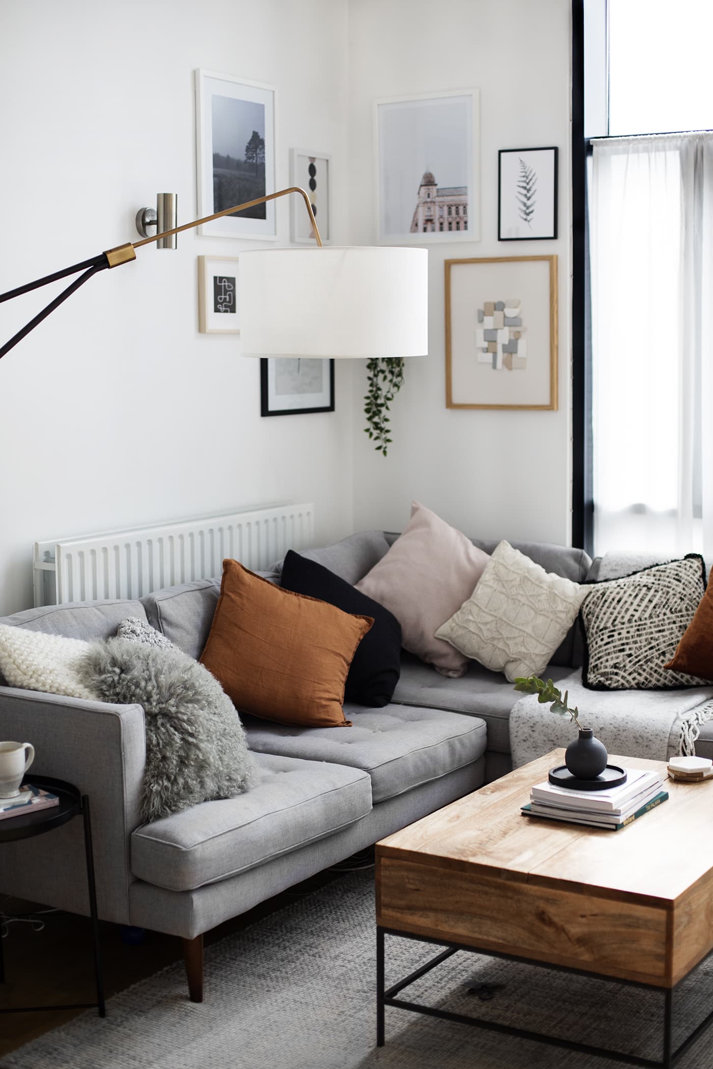 grey couch with orange pillows