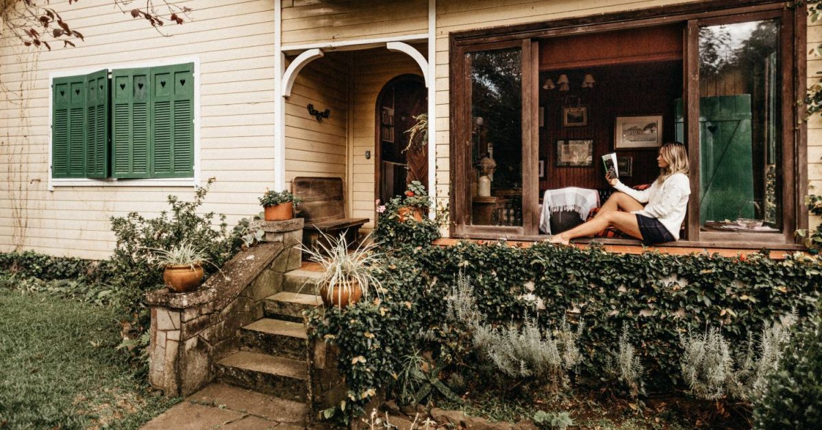 woman reading on front porch