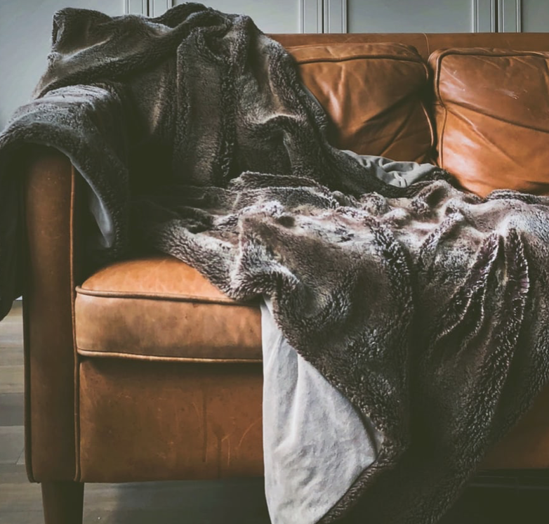 Leather couch with a blanket