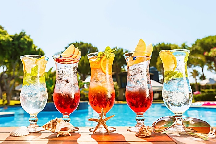 Craft cocktails near the pool. Vacation, summer, holiday, luxury resort concept. Horizontal