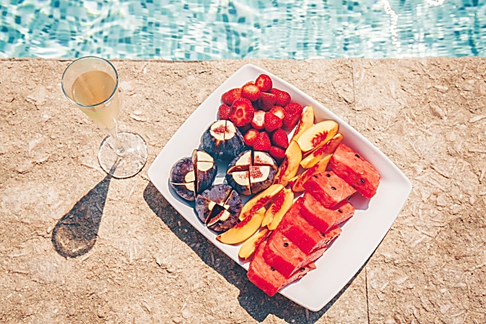 Exotic tropical fruit plate on the pool edge.