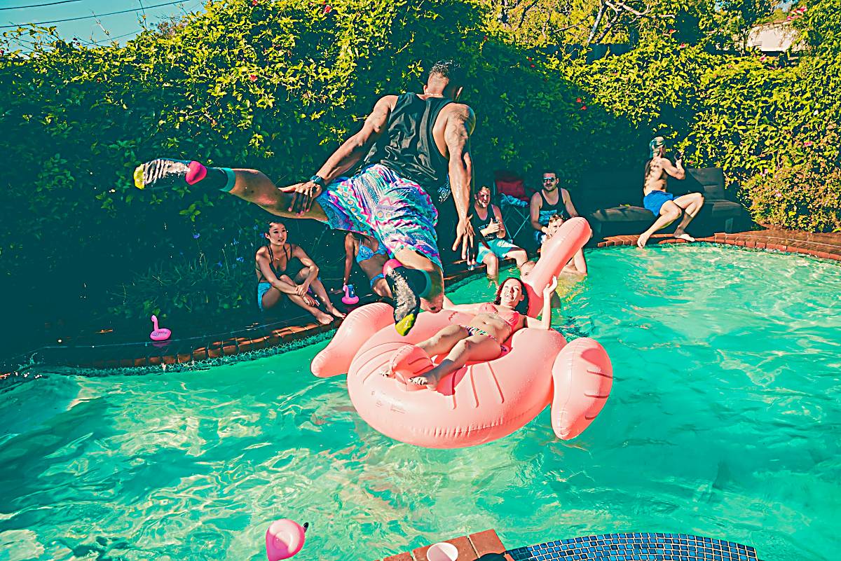 man jumping into pool