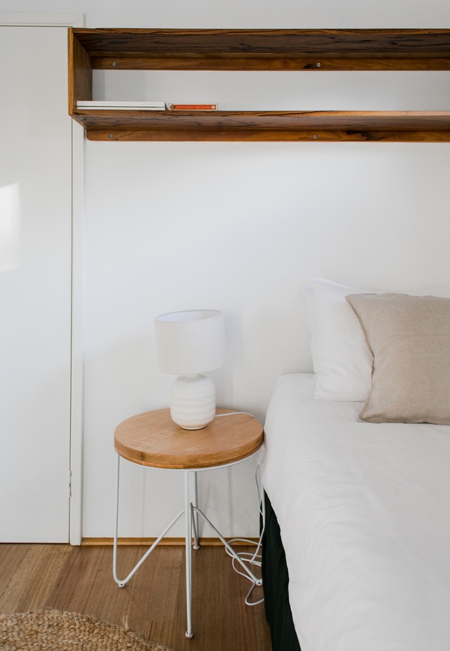 white bedroom with timber