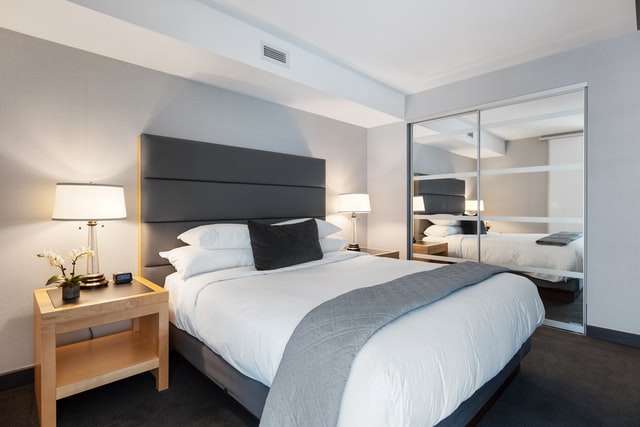 grey bedroom with oversized grey bedhead