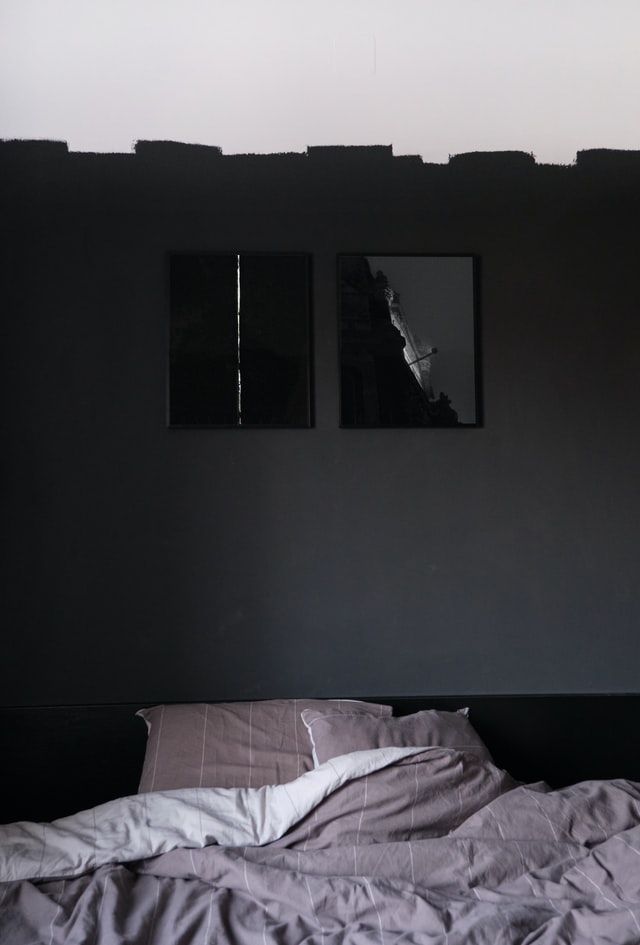 black bedroom with unfinished paint