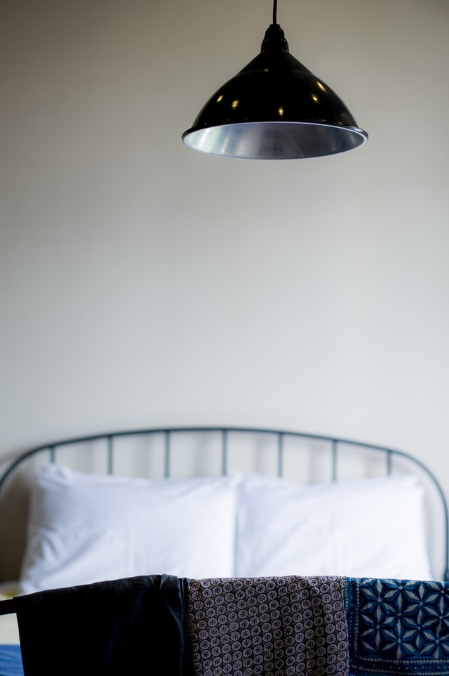 black bedroom with black pendant