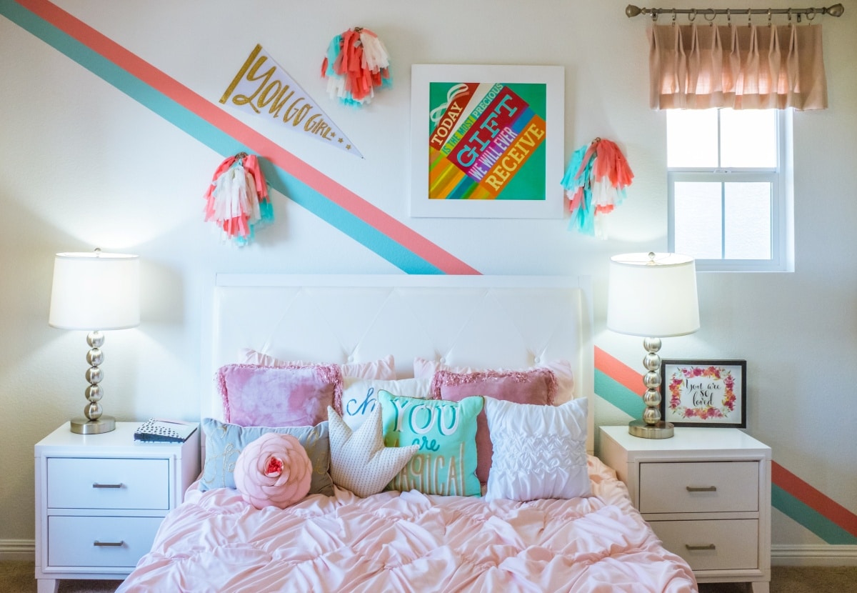 Bedroom with bright blue and pink wall accents