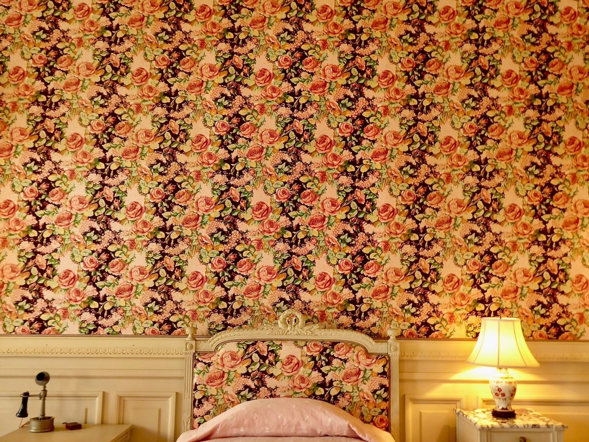 Floral wall above bed