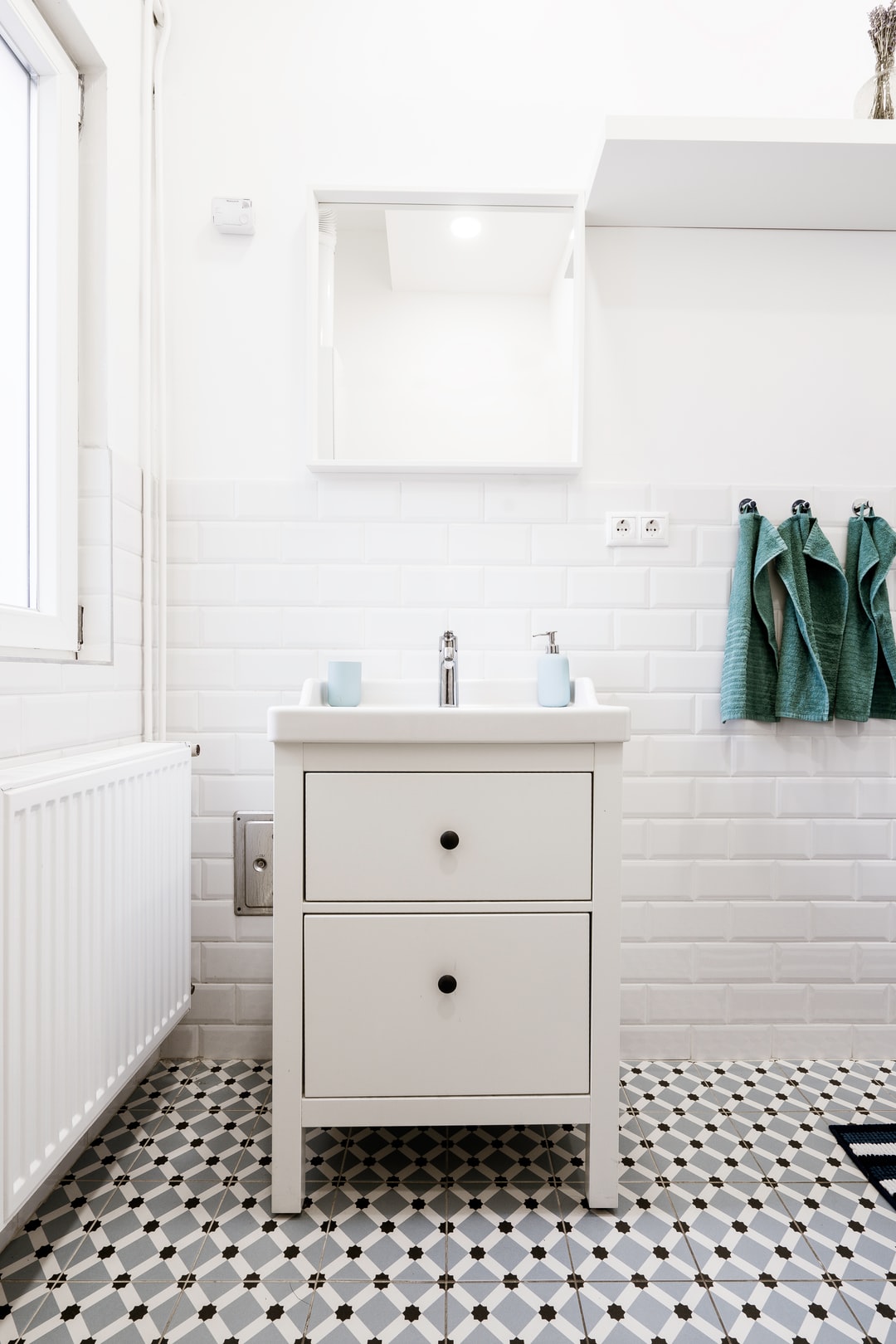 A white tiled bathroom setting
