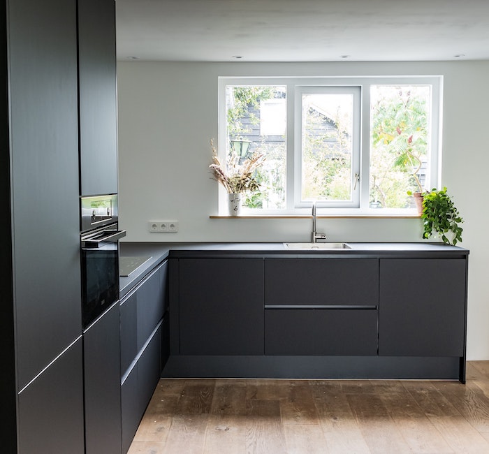 black kitchen with window over sink without a window covering