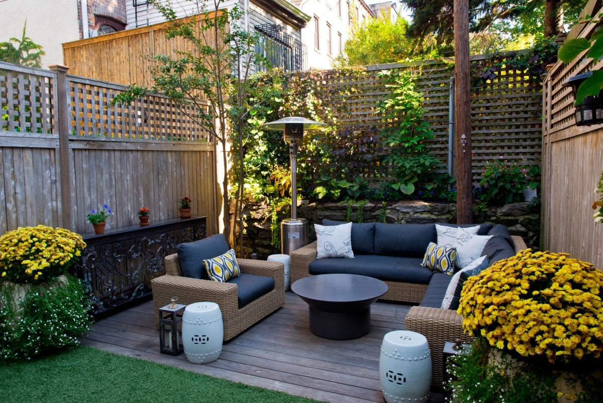 Outdoor living space with cushioned sofas and coffee table