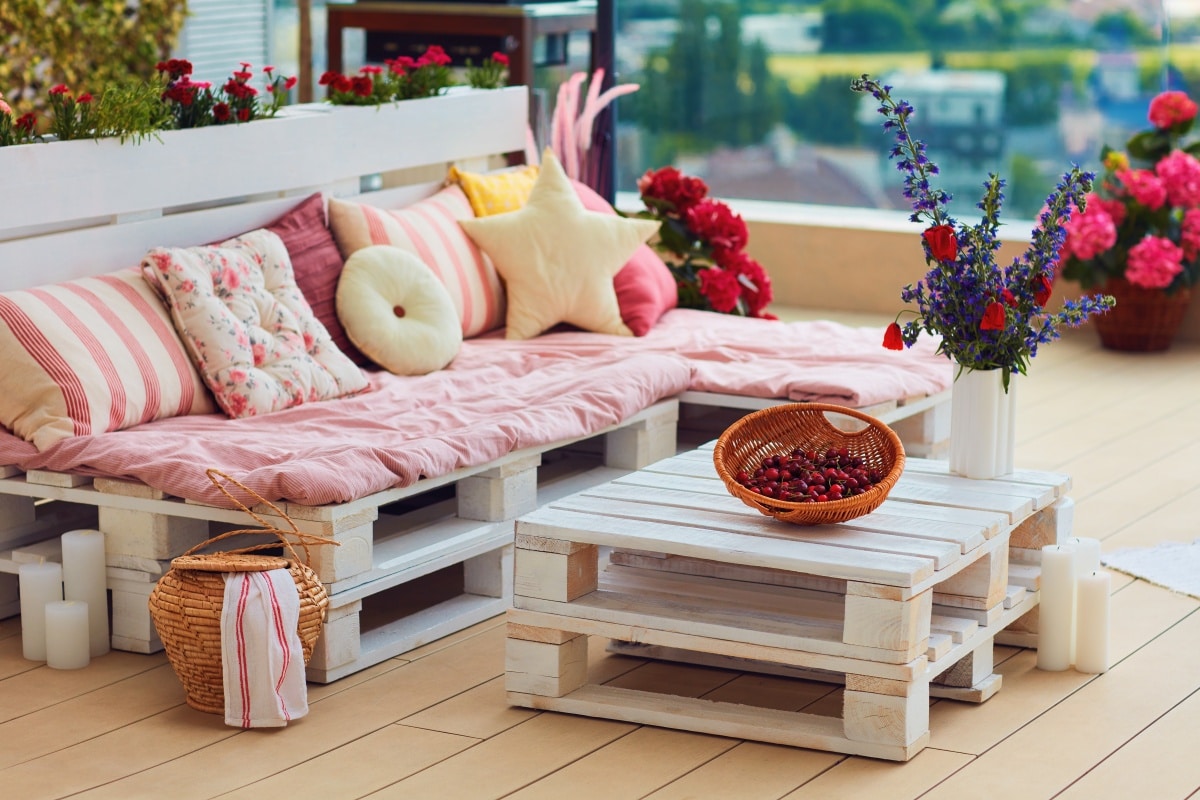 pallet furniture with colorful pillows at a summer patio