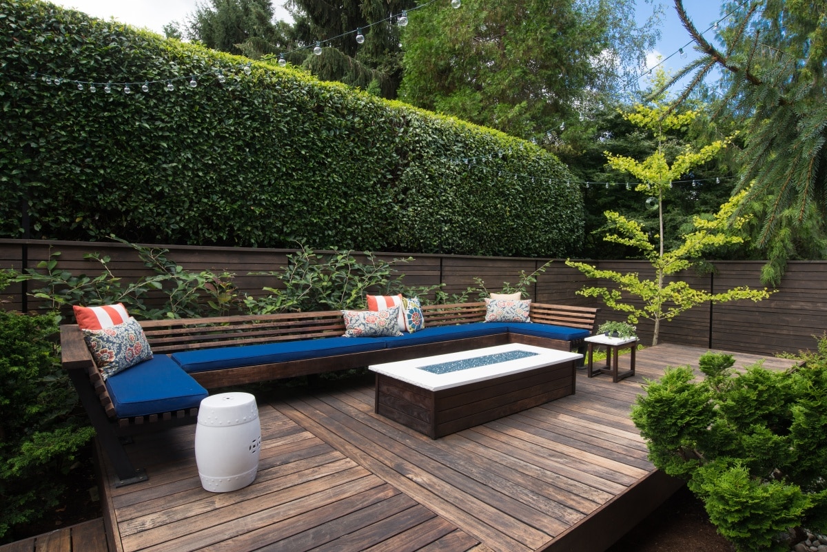 Contemporary outdoor bench with pillows on a wooden deck