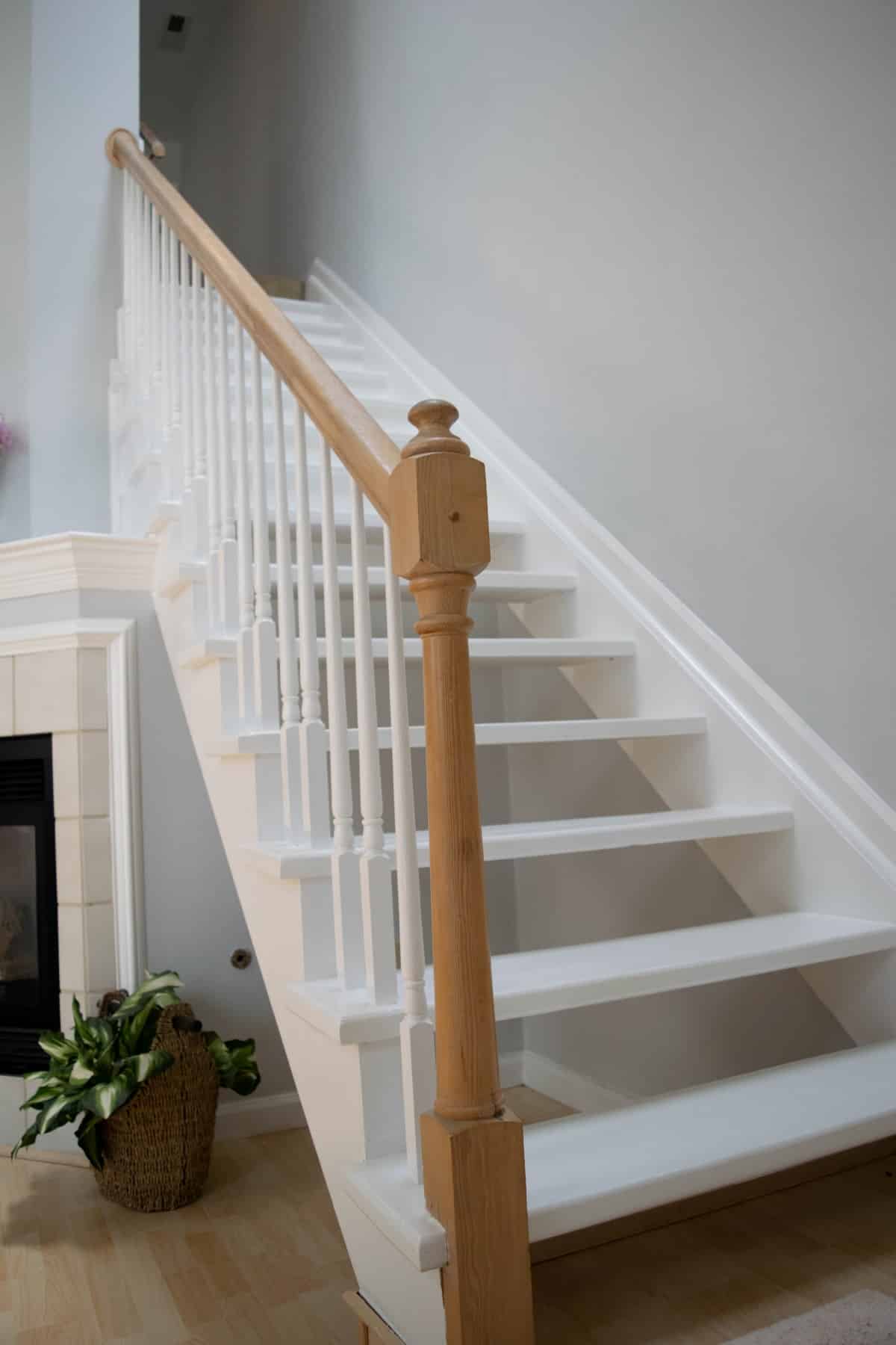 white and brown stairs with wood railings