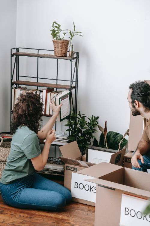 couple unpacking books from boxes