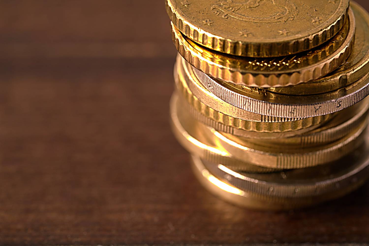 Euro coins stacked on each other in different positions 