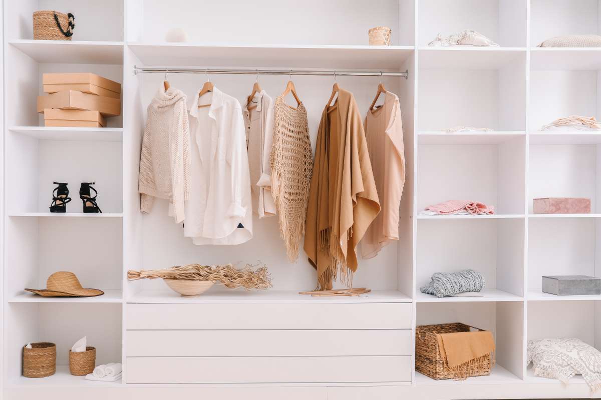 brown clothes inside white wardrobe