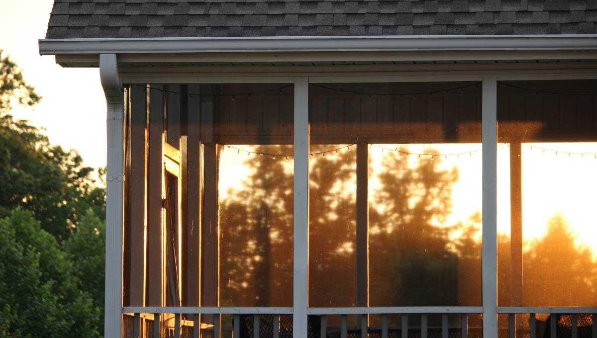 screened in porch with sunset