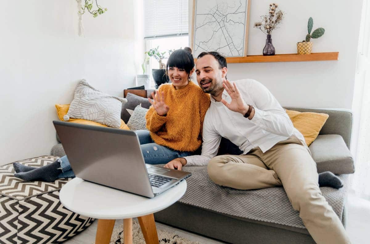 man and woman video chatting using laptop