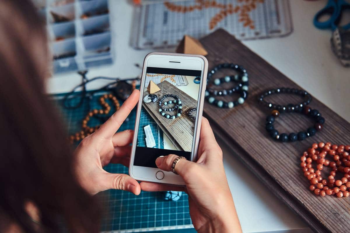 woman taking photos of handmade jewellery