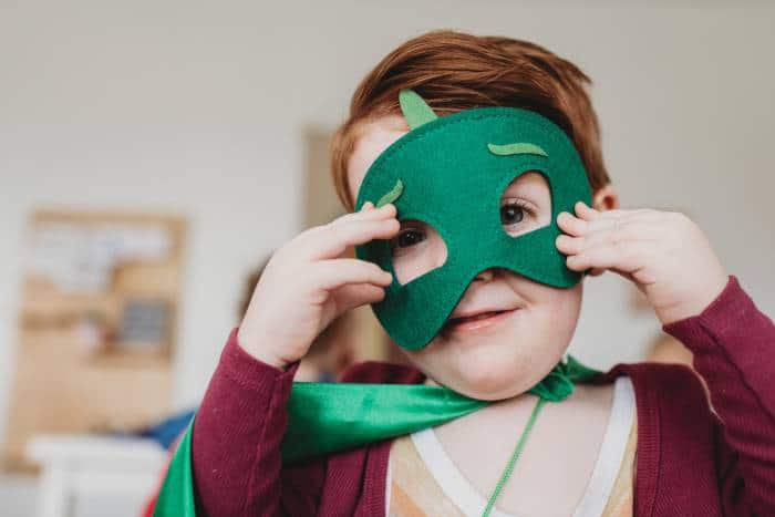 little boy playing dress up