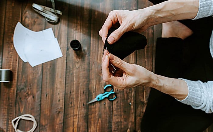 Person sewing a face mask by hand