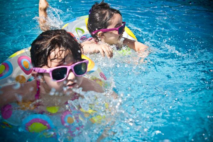 little gitls swimming in pool