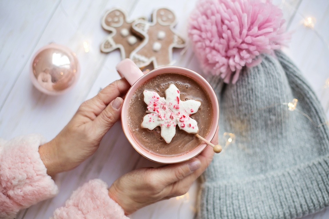 holding a cup of cocoa